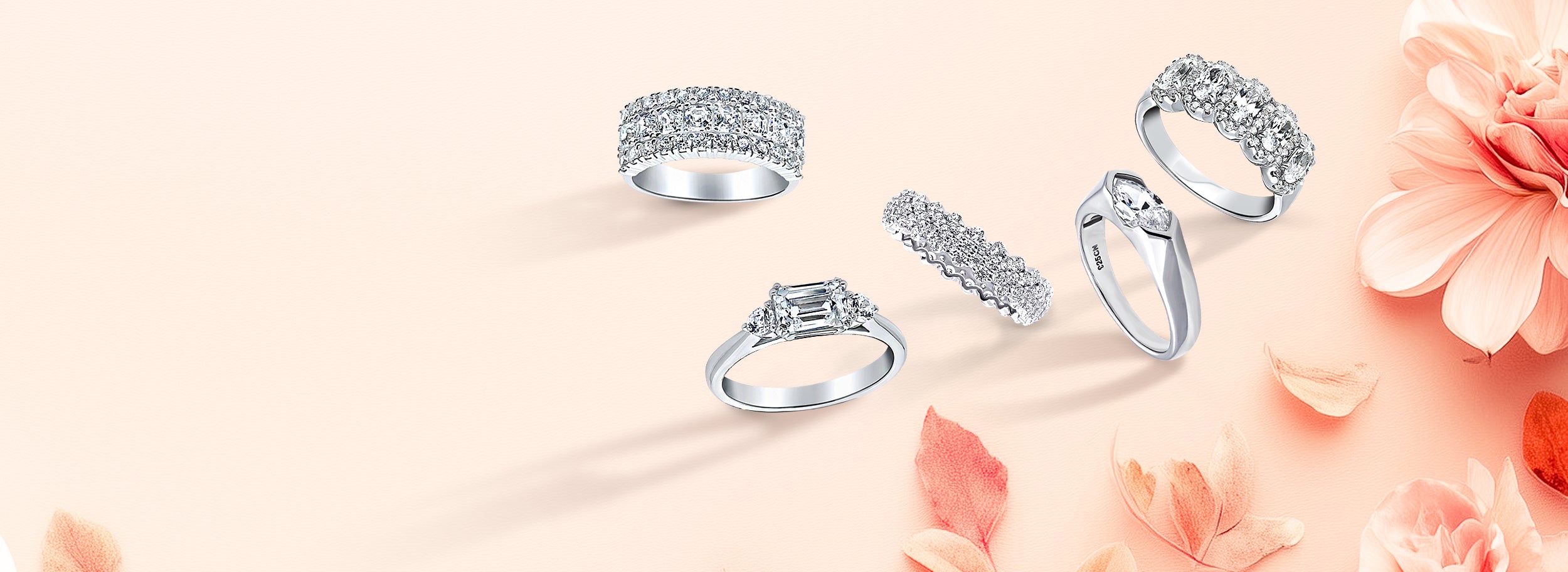 assorted silver cz rings on a floral background.