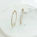 Flatlay view of CZ Medium Inside-Out Hoop Earrings in Sterling Silver 1.4 inch, Yellow Gold Flashed