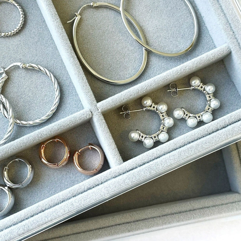 Flatlay view of Cable Medium Hoop Earrings in Sterling Silver 1.2 inch, Yellow Gold Flashed