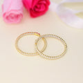 Flatlay view of CZ Large Inside-Out Hoop Earrings in Sterling Silver 1.9 inch, Yellow Gold Flashed