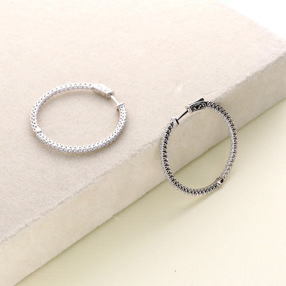 Flatlay view of CZ Medium Inside-Out Hoop Earrings in Sterling Silver 1.4 inch, Rhodium Plated