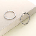 Flatlay view of CZ Medium Inside-Out Hoop Earrings in Sterling Silver 1.4 inch, Rhodium Plated