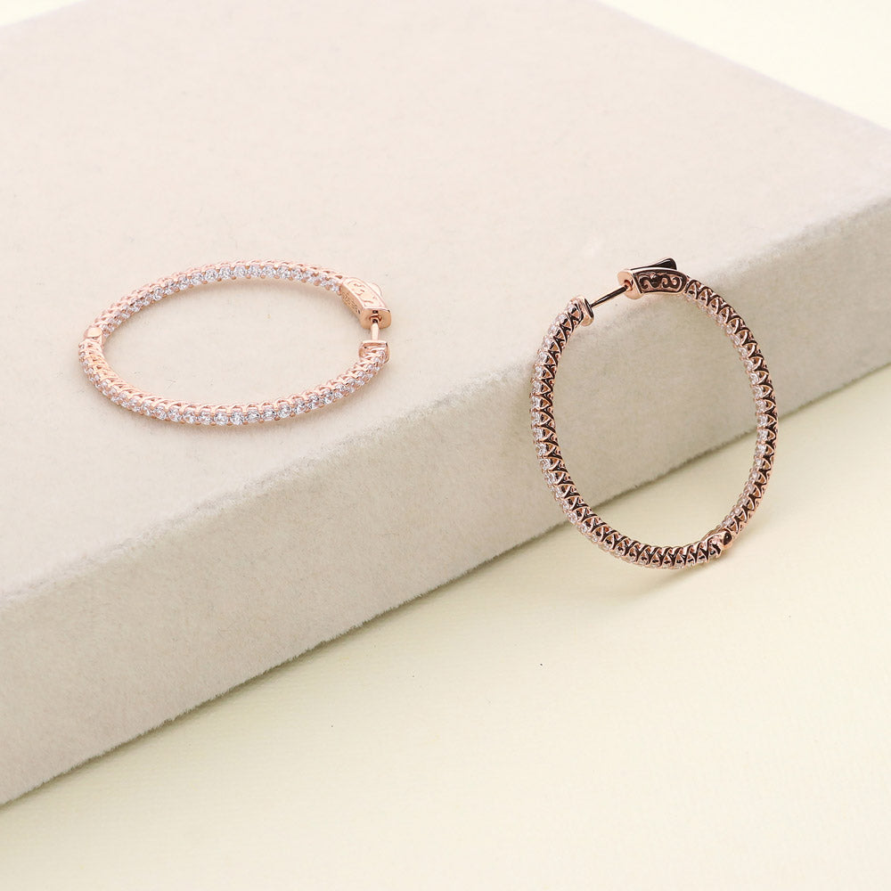 Flatlay view of CZ Medium Inside-Out Hoop Earrings in Sterling Silver 1.4 inch, Rose Gold Flashed