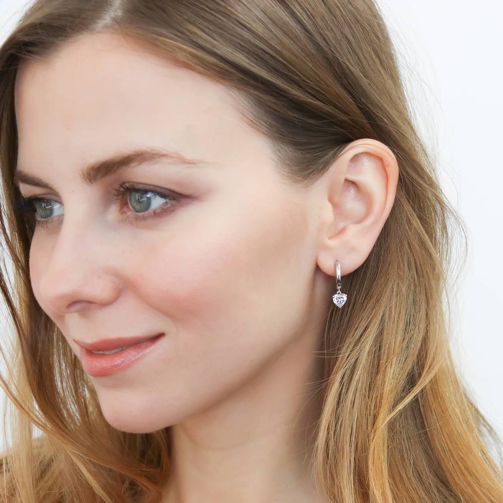 Model wearing Solitaire CZ Huggie Earrings in Sterling Silver 0.5 inch, 10 of 20