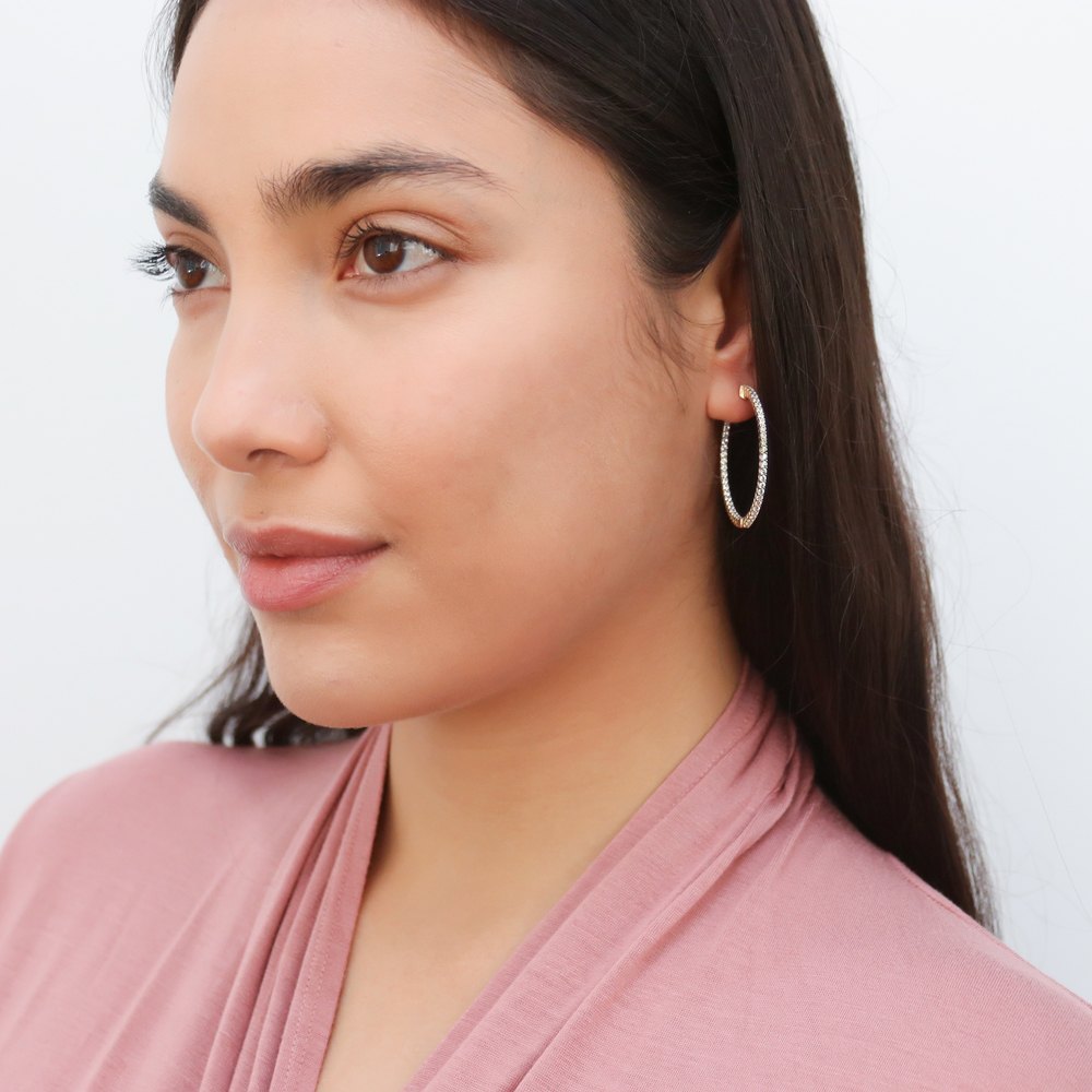 Model wearing CZ Medium Inside-Out Hoop Earrings in Sterling Silver 1.4 inch, Yellow Gold Flashed