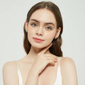 Model wearing CZ Small Huggie Earrings in Sterling Silver 0.5 inch, Frosty Mint Color