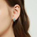 Model wearing CZ Small Huggie Earrings in Sterling Silver 0.5 inch, Frosty Mint Color