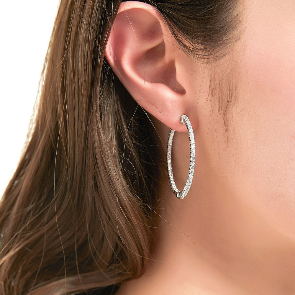 Model wearing CZ Medium Inside-Out Hoop Earrings in Sterling Silver 1.4 inch, Rhodium Plated