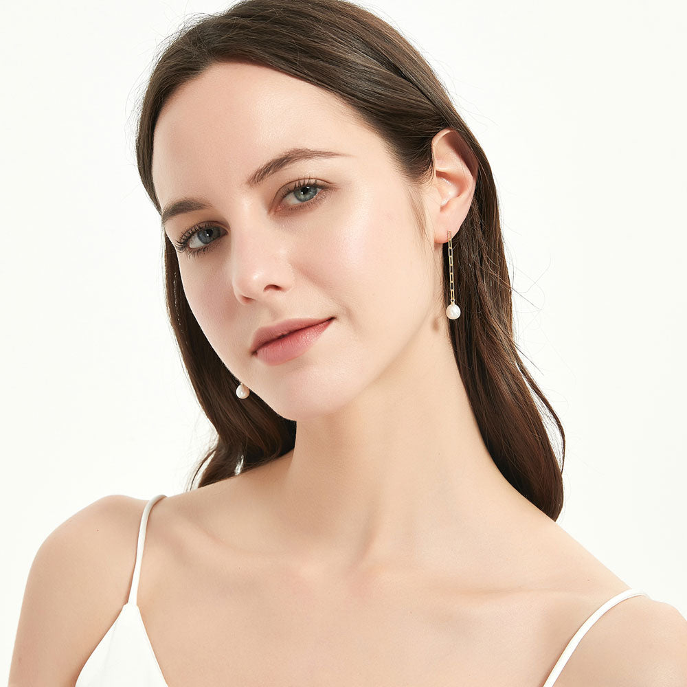 Model wearing Solitaire Oval Cultured Pearl Earrings in Sterling Silver, 5 of 8