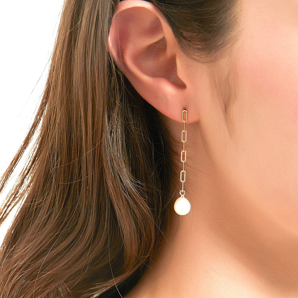 Model wearing Solitaire Oval Cultured Pearl Earrings in Sterling Silver, 2 of 8