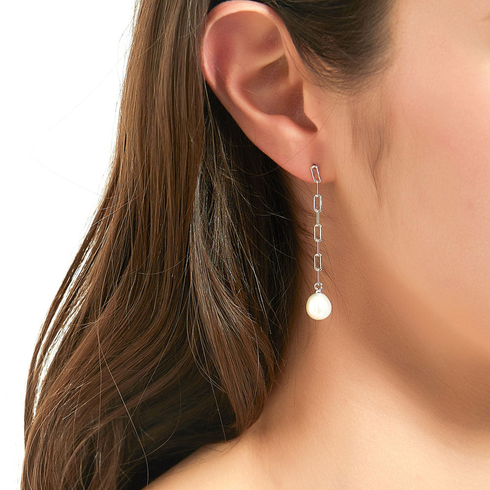 Model wearing Solitaire Oval Cultured Pearl Earrings in Sterling Silver, 4 of 8