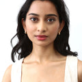 Model wearing Dome CZ Small Huggie Earrings in Sterling Silver 0.5 inch, Yellow Gold Flashed