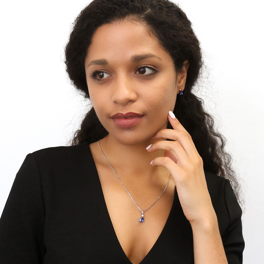 Model wearing Solitaire 2-Stone Pear Medium Necklace in Sterling Silver 1ct, Tanzanite Color