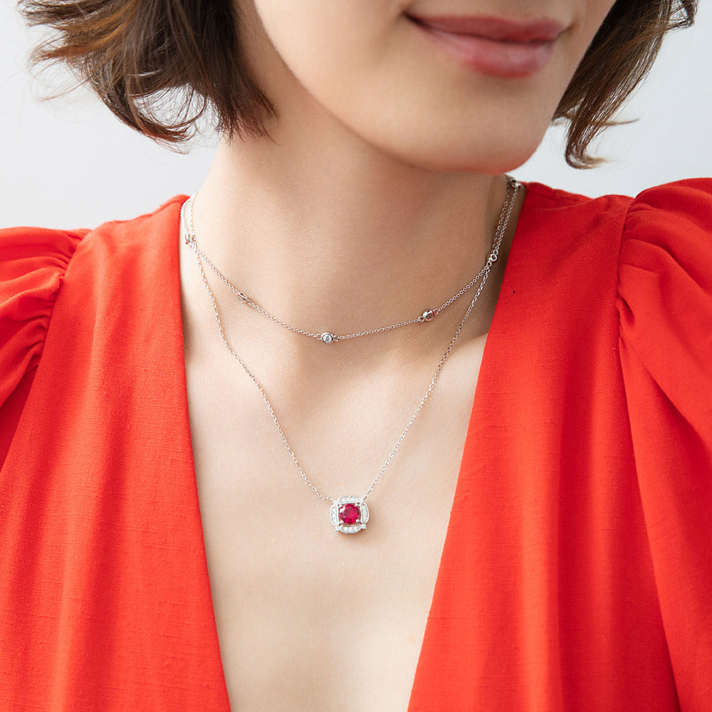 Model wearing Flower Halo CZ Necklace and Earrings in Sterling Silver, Ruby Color