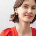 Model wearing Halo Clover Oval CZ Earrings in Sterling Silver, Clear Color