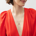 Model wearing Solitaire 2-Stone Pear Medium Necklace in Sterling Silver 1ct, Tanzanite Color