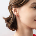 Model wearing Solitaire 2-Stone Pear Stud Earrings in Sterling Silver 1.4ct, Green Color