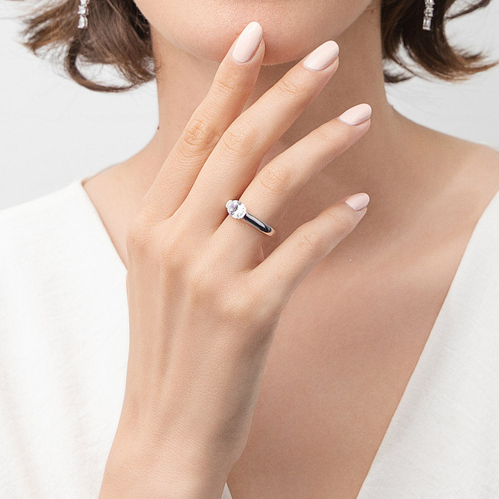 Model wearing Solitaire 1.2ct Half Bezel Set Oval CZ Ring in Sterling Silver, 2 of 9