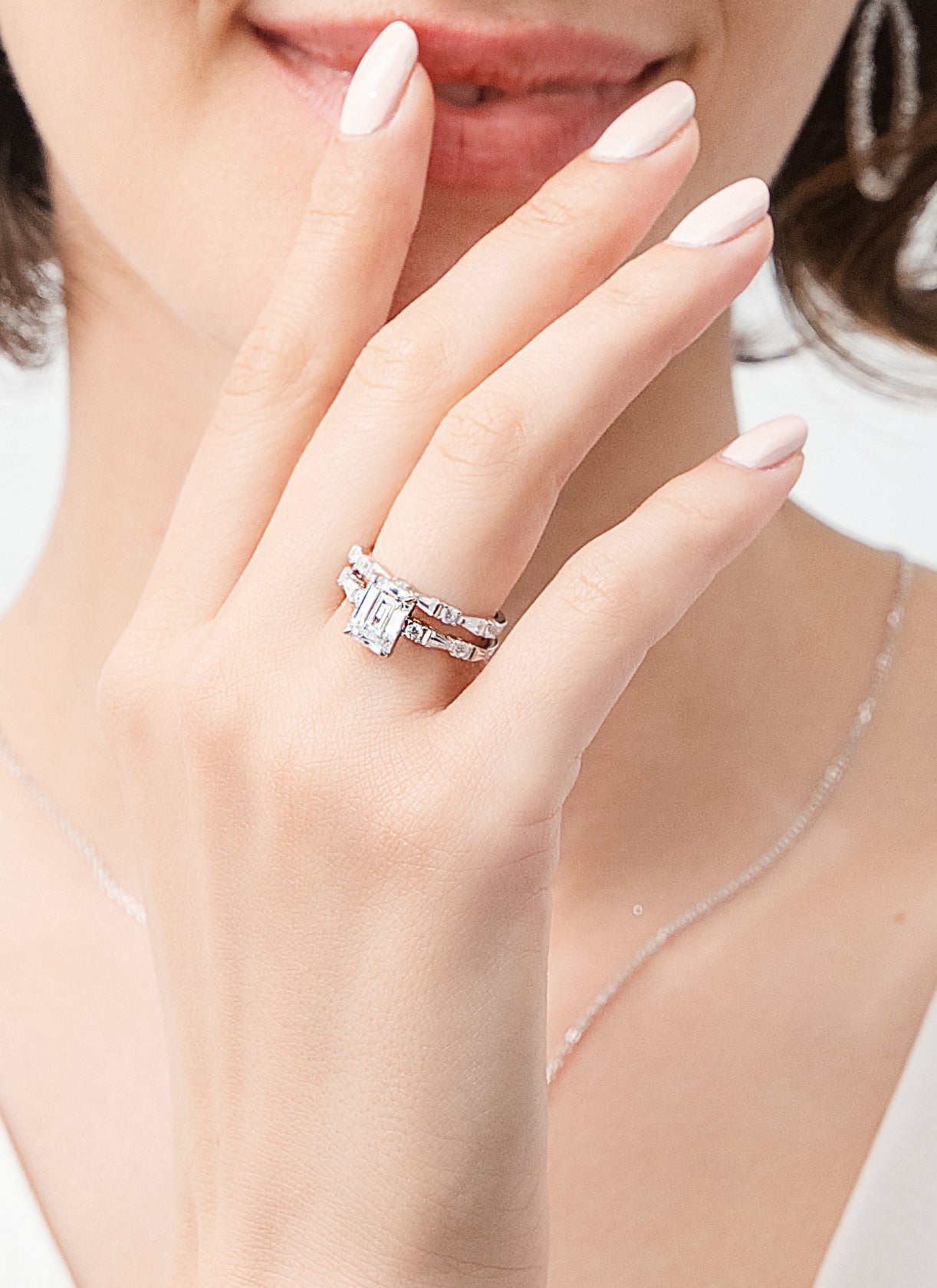 Model wearing a emerald cut ring set