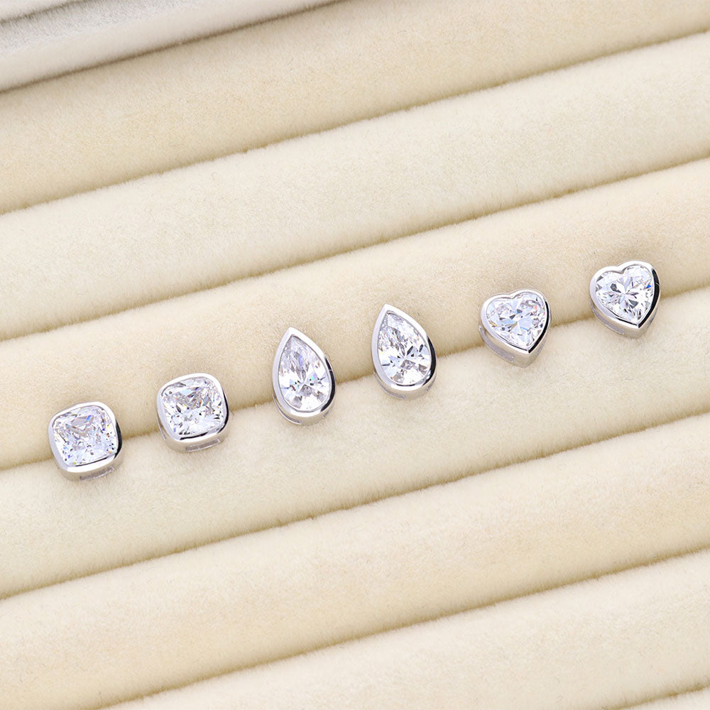 Flatlay view of Solitaire Bezel Set Pear CZ Stud Earrings in Sterling Silver 1.6ct, 6 of 7