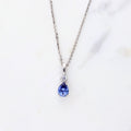 Flatlay view of Solitaire 2-Stone Pear Medium Necklace in Sterling Silver 1ct, Tanzanite Color