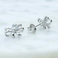 Flatlay view of Bow Tie Ribbon Stud Earrings in Sterling Silver, Style 1