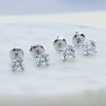 Flatlay view of Solitaire CZ Stud Earrings in Sterling Silver, 4mm