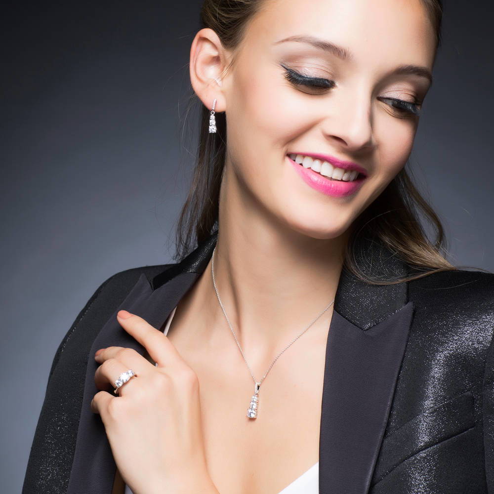 Model wearing 3-Stone Graduated Round CZ Pendant Necklace in Sterling Silver, 2 of 7