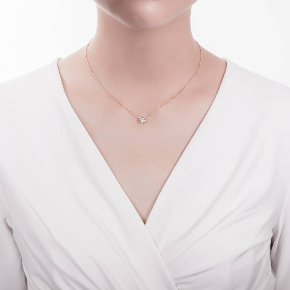 Model wearing Solitaire 0.9ct Bezel Set Round CZ Necklace in Sterling Silver, 2 Piece, 2 of 11