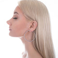 Model wearing CZ Large Inside-Out Hoop Earrings in Sterling Silver 2.2 inch, Rhodium Plated