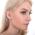 Model wearing Dome Mini Huggie Earrings in Sterling Silver 0.45 inch, Rhodium Plated