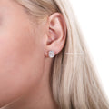 Model wearing Solitaire Emerald Cut CZ Stud Earrings in Sterling Silver, 6mm x 4mm