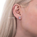 Model wearing Solitaire Emerald Cut CZ Stud Earrings in Sterling Silver, 6mm x 4mm