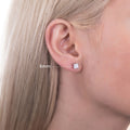 Model wearing Solitaire Princess CZ Stud Earrings in Sterling Silver, 4mm