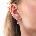 Model wearing Solitaire 4ct Cushion CZ Leverback Earrings in Sterling Silver, Yellow Gold Flashed