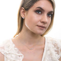 Model wearing Solitaire 1.6ct Crown Set CZ Stud Earrings in Sterling Silver, Rose Gold Flashed