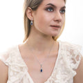 Model wearing Halo Art Deco Marquise CZ Earrings in Sterling Silver, Sapphire Color