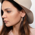 Model wearing Oval CZ Medium Inside-Out Hoop Earrings in Sterling Silver 1.4 inch, Yellow Gold Flashed