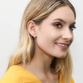 Model wearing Dome CZ Small Huggie Earrings in Sterling Silver 0.5 inch, Yellow Gold Flashed