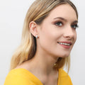 Model wearing Dome CZ Small Huggie Earrings in Sterling Silver 0.5 inch, Yellow Gold Flashed