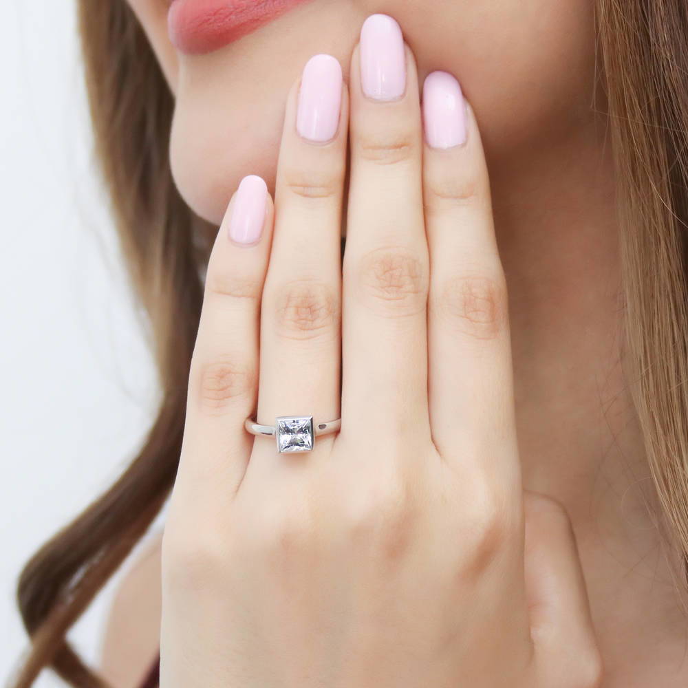 Model wearing Solitaire 1.2ct Bezel Set Princess CZ Ring in Sterling Silver, 2 of 8
