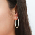 Model wearing CZ Medium Inside-Out Hoop Earrings in Sterling Silver 1.4 inch, Yellow Gold Flashed