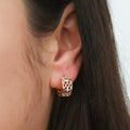 Model wearing Clover CZ Small Huggie Earrings in Sterling Silver 0.55 inch, Yellow Gold Flashed