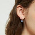 Model wearing Kaleidoscope Solitaire CZ Leverback Earrings in Sterling Silver, Purple Aqua Color