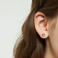 Model wearing Solitaire Kaleidoscope CZ Stud Earrings in Sterling Silver 1.6ct, Red Orange Color