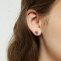 Model wearing Solitaire Kaleidoscope CZ Stud Earrings in Sterling Silver 1.6ct, Purple Aqua Color