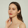 Model wearing Solitaire Emerald Cut CZ Leverback Earrings in Sterling Silver, Yellow Gold Flashed