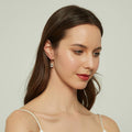 Model wearing Solitaire Emerald Cut CZ Leverback Earrings in Sterling Silver, Yellow Gold Flashed