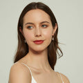 Model wearing Solitaire Emerald Cut CZ Leverback Earrings in Sterling Silver, Yellow Gold Flashed