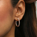 Model wearing Oval CZ Medium Inside-Out Hoop Earrings in Sterling Silver 0.84 inch, Rose Gold Flashed